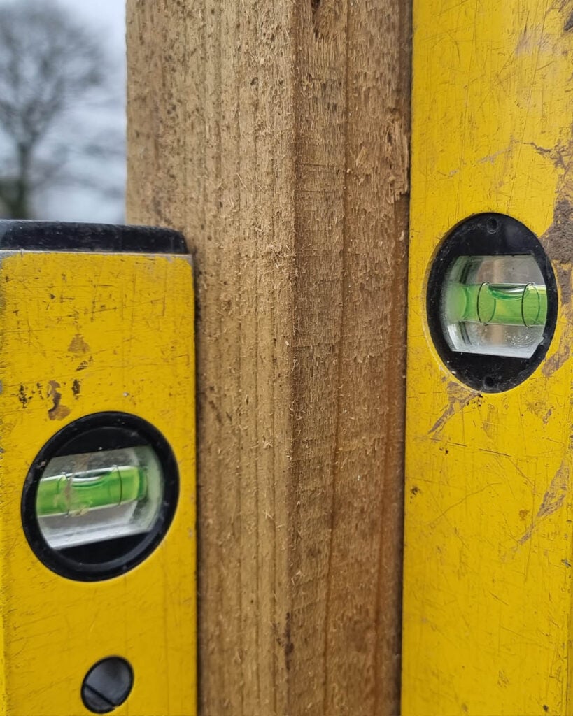 Using two spirit levels to check post is straight